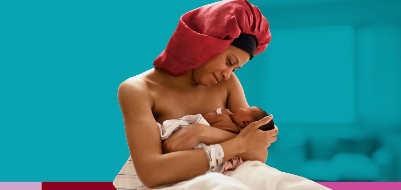 A mom holding her newborn baby and looking into her eyes on a blue background