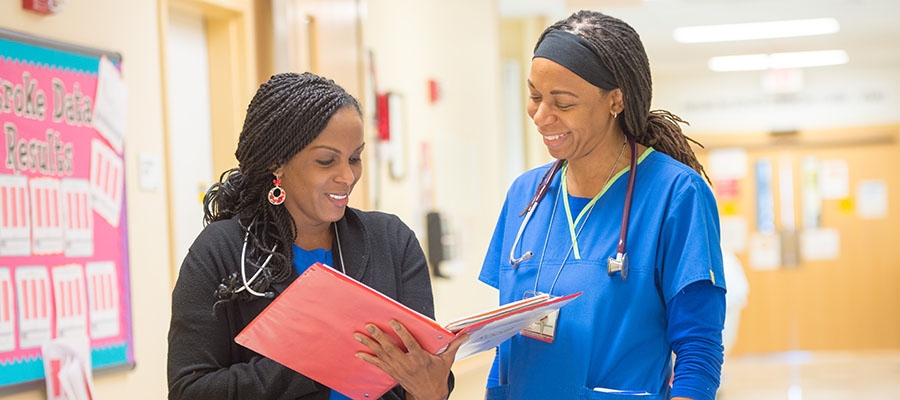 Temple nurses reviewing folder